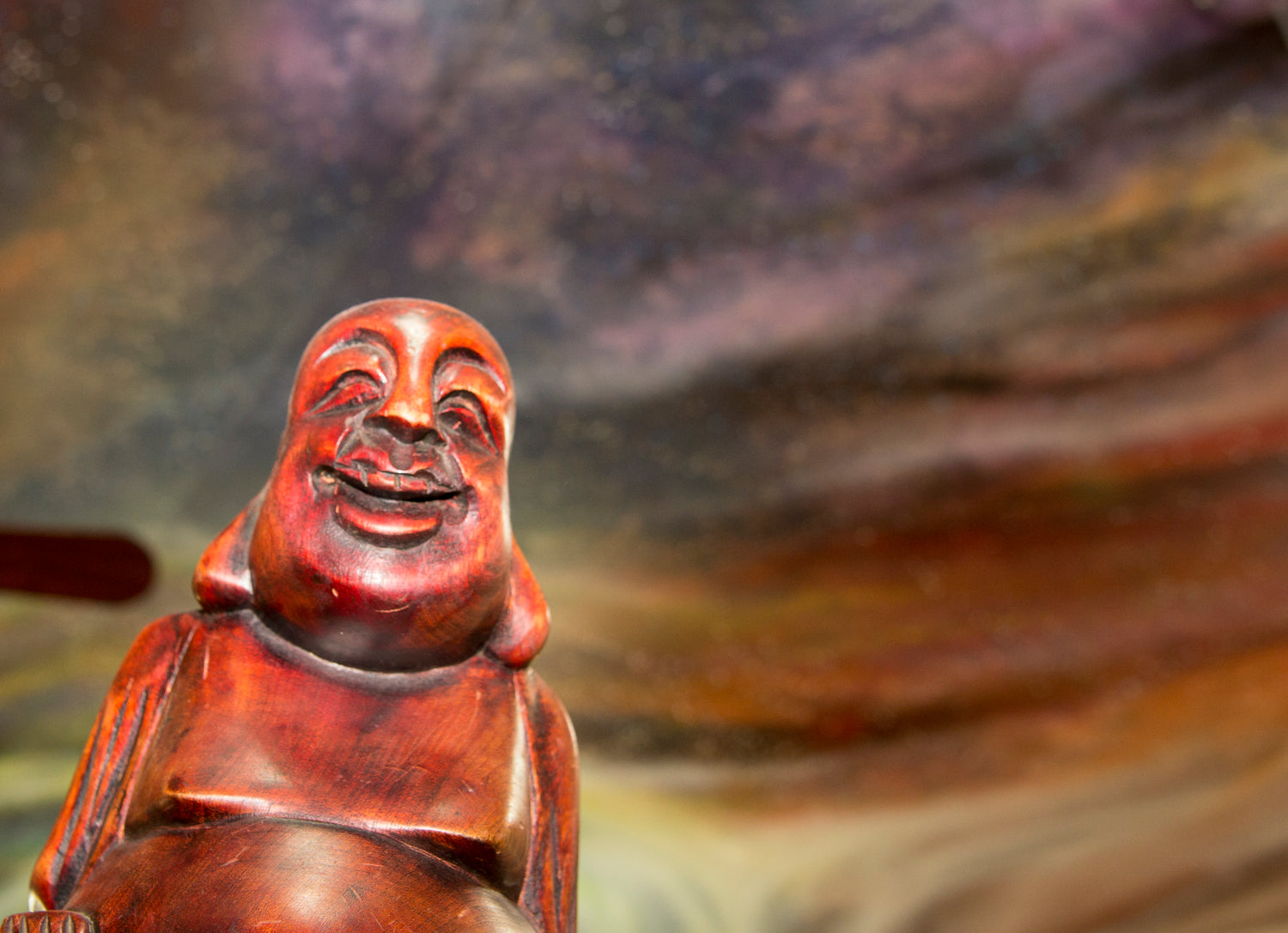 wooden buddha statue with painted sky in the the background, studio ceiling